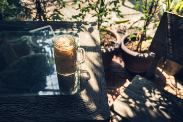 Ice coffee on the wooden table
