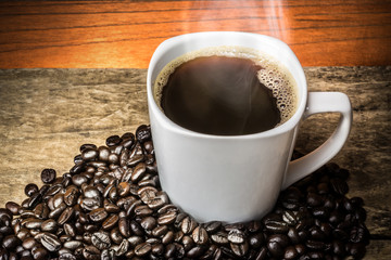 Coffee Cup and Beans on Wooden Table