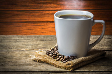 Coffee Cup and Beans on Wooden Table