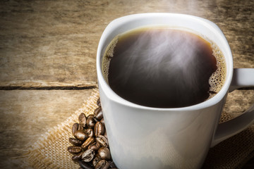 Coffee Cup and Beans on Wooden Table