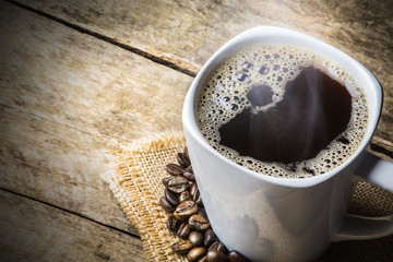 Coffee Cup and Beans on Wooden Table