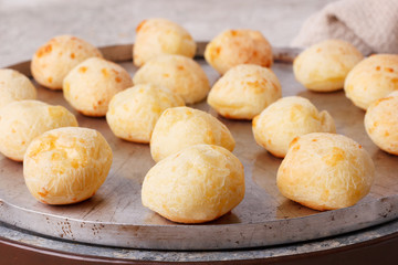 Brazilian snack cheese bread (pao de queijo) on oven-tray