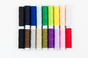 Colorful of roll sewing threads on white background