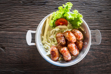 Grill sausages with metal plate on the table