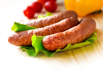 sausage and vegetables served on a wooden board for copy space
