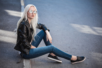 Stylish blonde girl posing outdoors