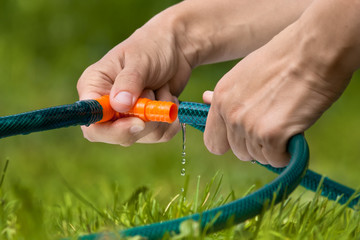 hands connected garden hose
