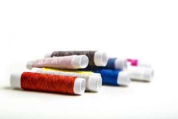 Fototapeta na wymiar Small multicolor sewing threads, Selective focus