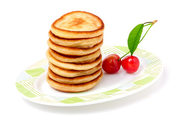 fritters on a plate with cherries isolated white background