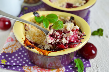 Cherry crumble with porridge on a concrete background