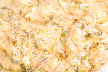 Fried chicken fillet in mushroom sauce.