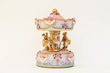 Beautiful toy carousel in the Baroque style. Horses, Tutti, Roses.