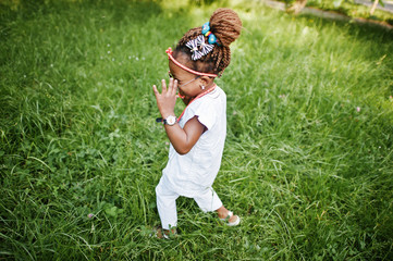 Fototapeta premium Amazing beautiful african american baby girl with sunglasses hav