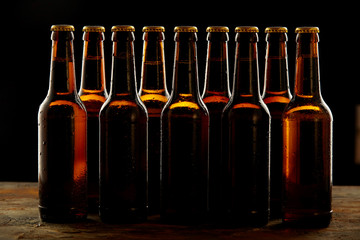 Group of sealed unlabelled brown beer bottles
