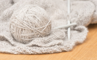 Ball of soft wool yarn and knitting needles