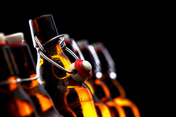 Row of glowing beer bottles with stoppers