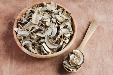 Dried porcini mushrooms on a wooden table. Rustic style.