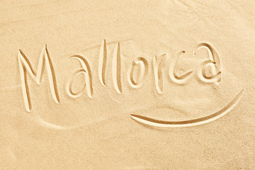 Mallorca handwritten in golden beach sand