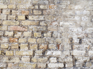 Old damaged rustic brick wall with plaster texture background