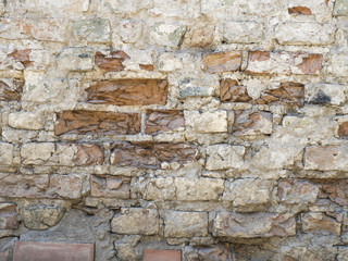 Old damaged red brick wall with plaster texture background