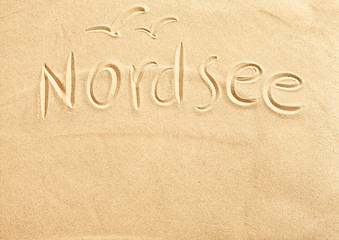 Nordsee and seagulls drawn in beach sand