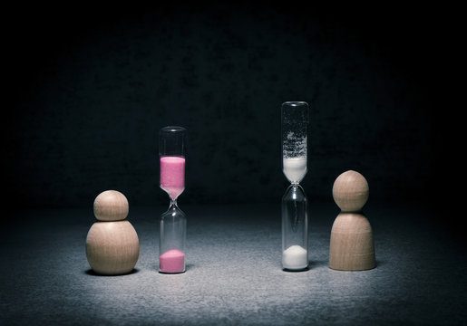 Time running out and aging symbol with small figure watching hourglass countdown. Concept of time pressure, life and gender.