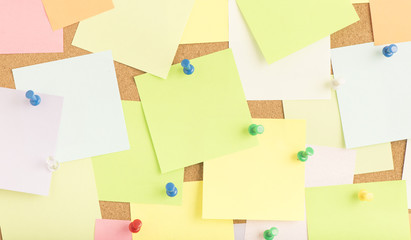Empty blank sticky notes on notice board in office. Background or backdrop for business...