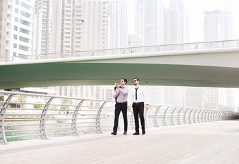 Businessmen walking at Dubai Marina.