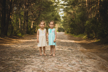 Fototapeta premium Two beautiful girls walking in the woods