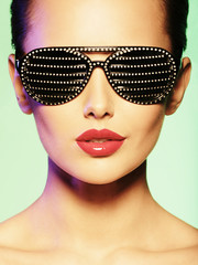 Fashion portrait of  woman wearing black sunglasses with diamon