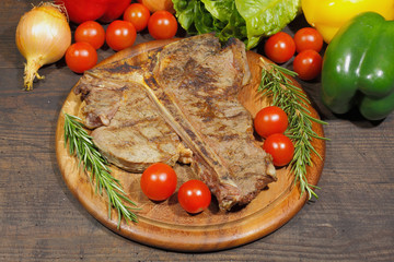 Grilled T bone steak with rosemary tomatoes, paprika onions and