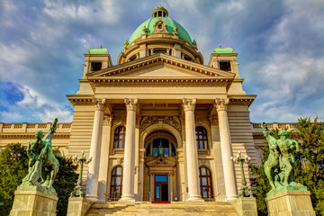 Entrance to the Serbian parliament with statues in front of the entrance, HDR image.