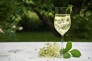 soft drink from elderflower syrup, juice, sparkling wine and soda in the garden