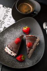 Chocolate cake with strawberries and cup of coffee