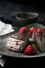 Chocolate cake with strawberries and cup of coffee