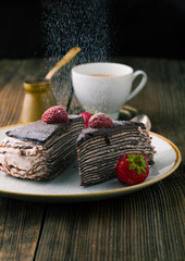 Chocolate cake with strawberries and cup of coffee