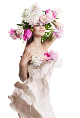 Young beautiful woman with flowers peonies. Beautiful flowers and easy cloth flying.
