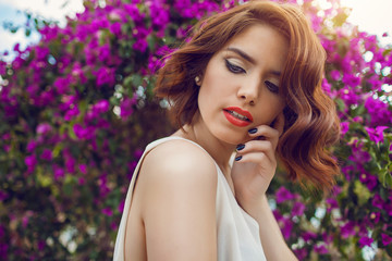 Obraz premium Fashion outdoor photo of beautiful young woman with red hair in elegant clothes.
