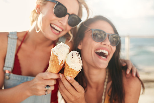 Female friends having fun and eating ice cream