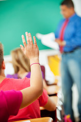 High School: Girl Raises Hand in Class