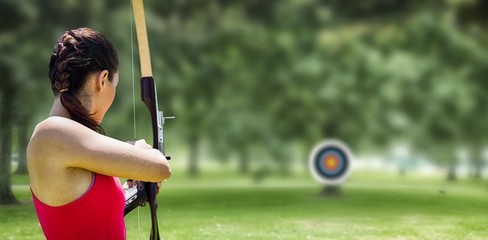 Image of rear view of sportswoman doing archery - obrazy, fototapety, plakaty