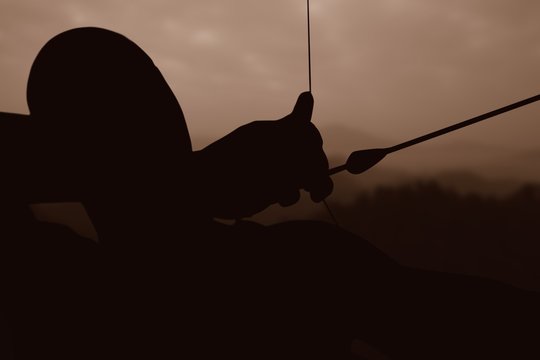 Image of close up of man stretching his bow