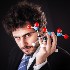 businessman holding tnt atomic structure