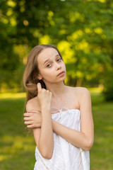 Outdoors portrait of beautiful young girl looking at you.