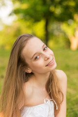 Fototapeta premium Outdoors portrait of beautiful young girl looking at you.