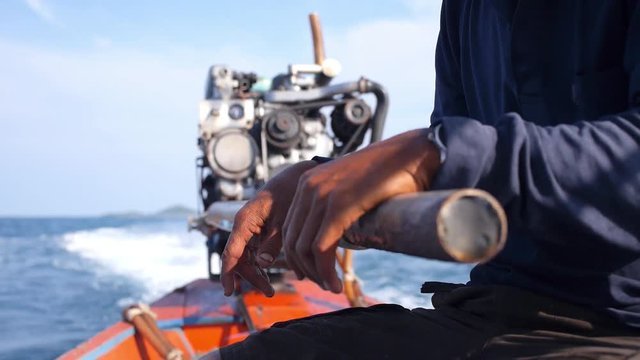 Close Up Hands of Fisherman on Long-tailed Boat, Motor Engine