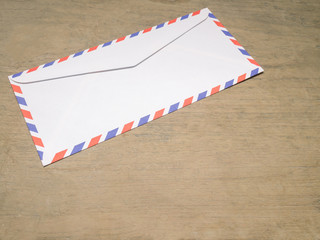 Air mail letter on wood background.