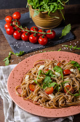 Spaghetti with mozzarella, cherry tomatoes and arugula
