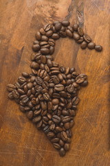 Brown coffee beans in shape of pepper, closeup of macro coffee b