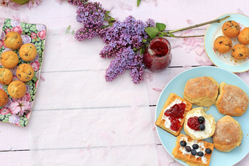 Spring romantic background with lilac with Scottish scones and waffers